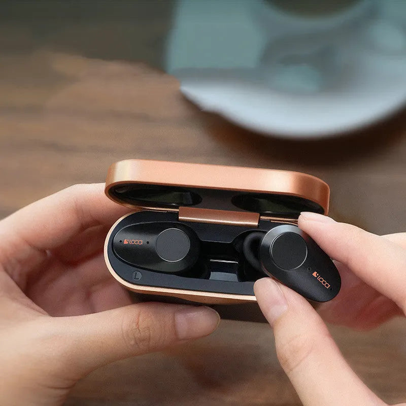 Black wireless Bluetooth headset with earpieces and charging stand, featuring ANC noise reduction.