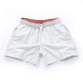 Men's polyester beach shorts with straight leg opening in multiple colours including black, white, and fluorescent yellow