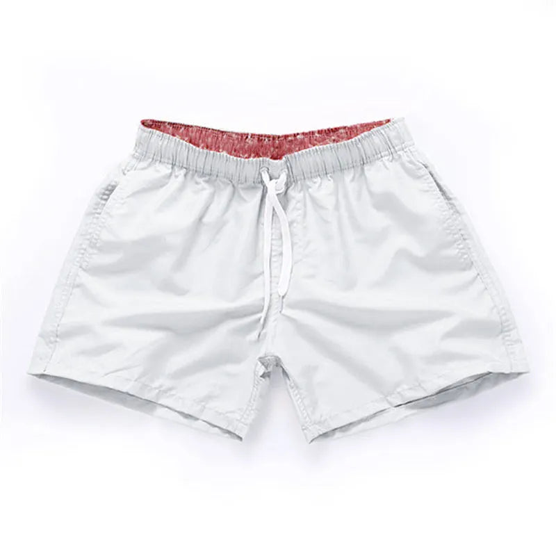 Men's polyester beach shorts with straight leg opening in multiple colours including black, white, and fluorescent yellow
