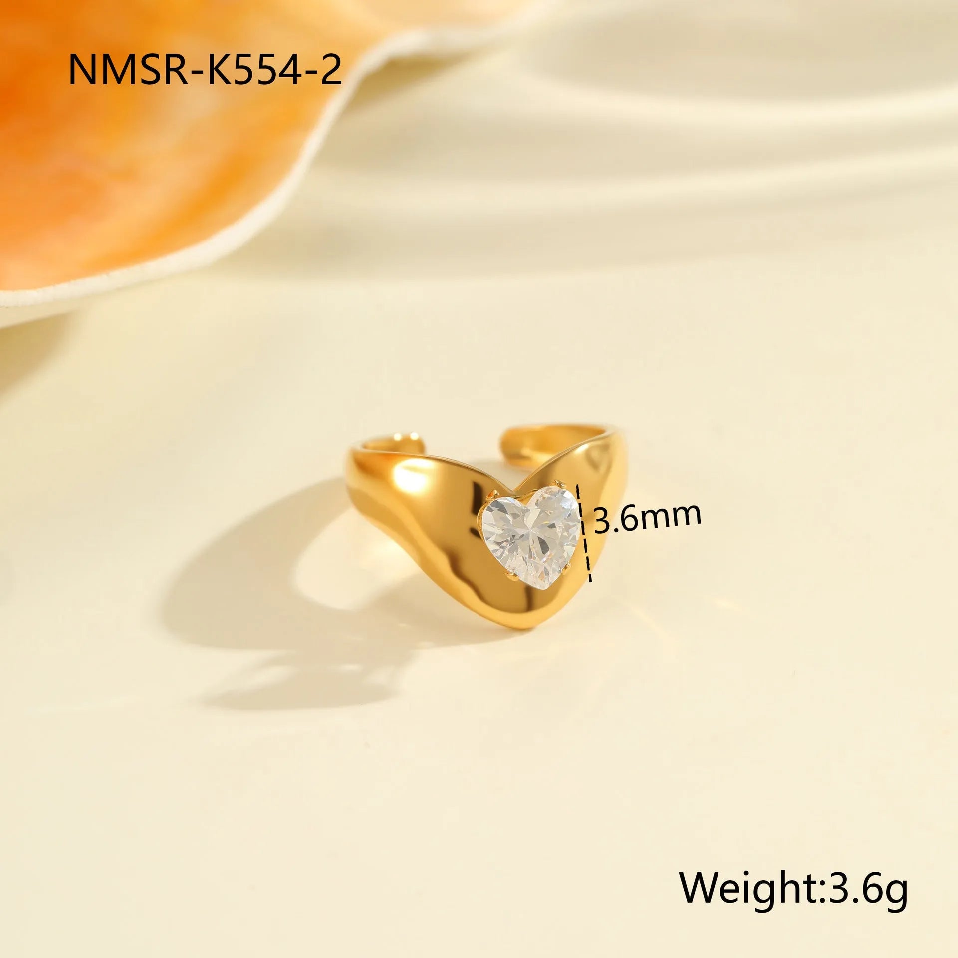 Women's geometric zircon ring with adjustable open mouth design on a hand.