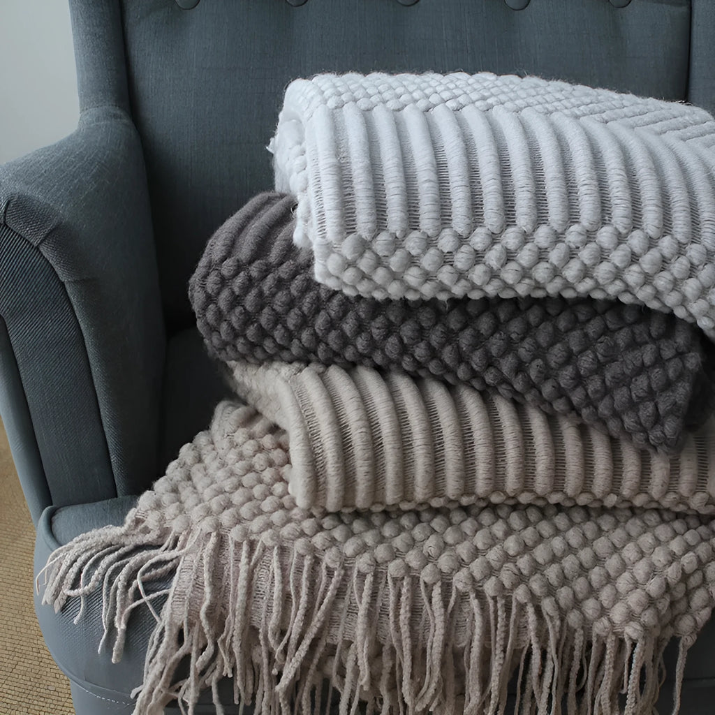 Small light grey polyester nap blanket folded, showing its 127cm by 170cm size.
