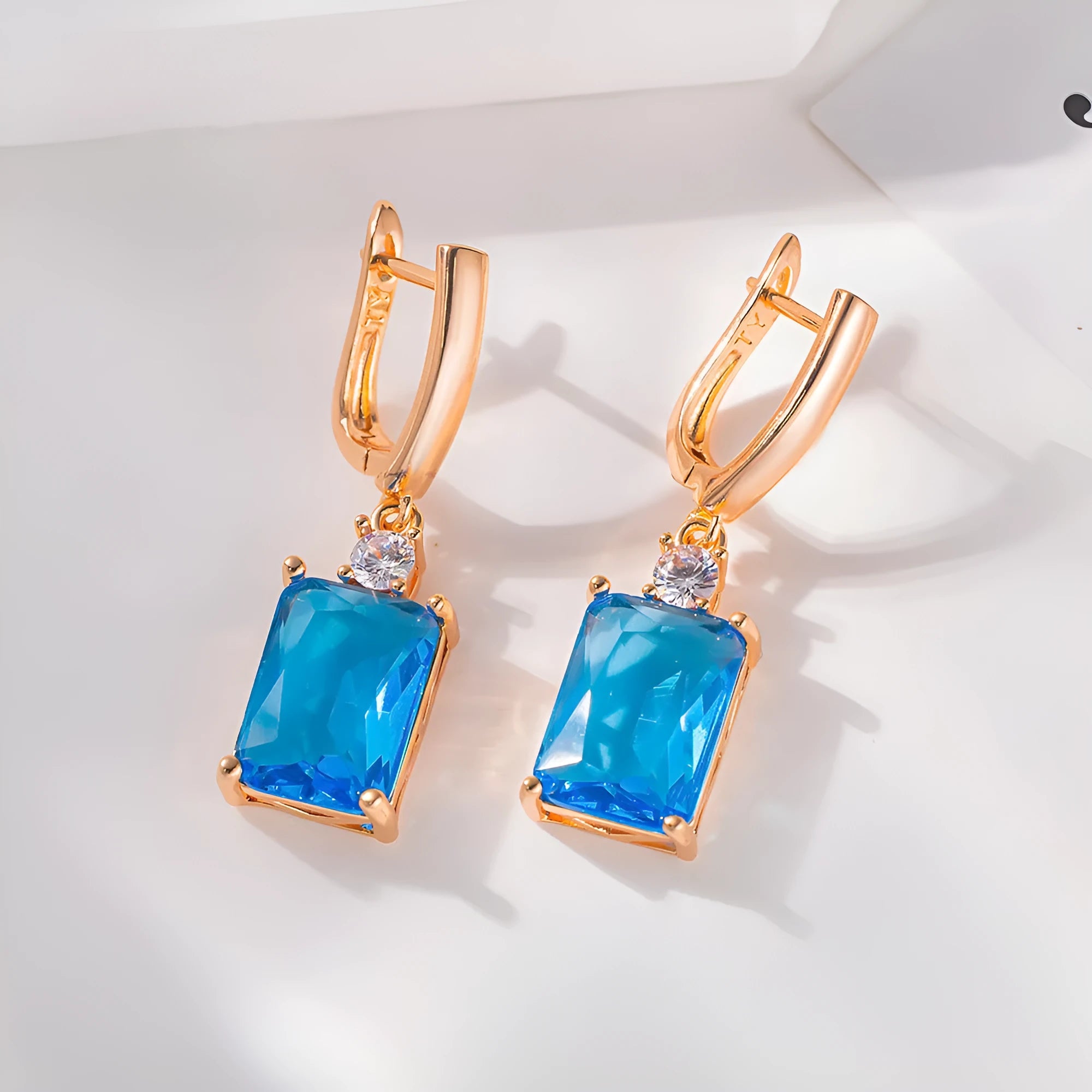 Square geometric copper earrings with gold electroplated finish showing quadrilateral shape