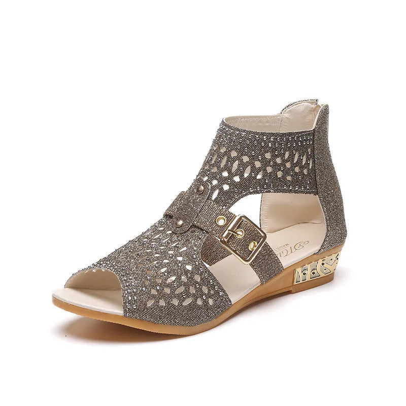Women's beige flat sandals with back zip closure and low wedge heel.