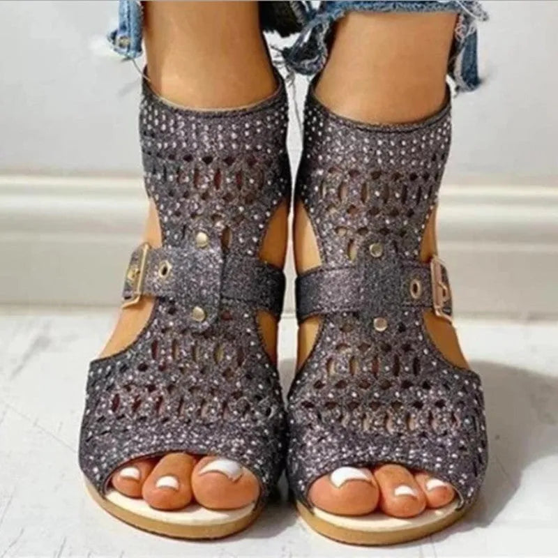 Women's beige flat sandals with back zip closure and low wedge heel.