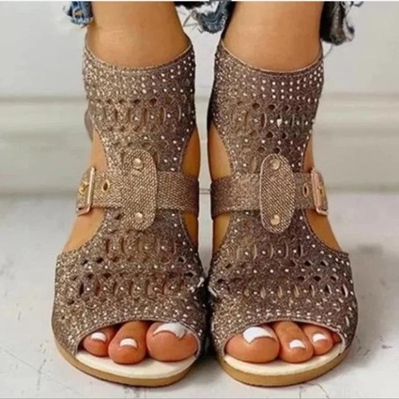 Women's beige flat sandals with back zip closure and low wedge heel.