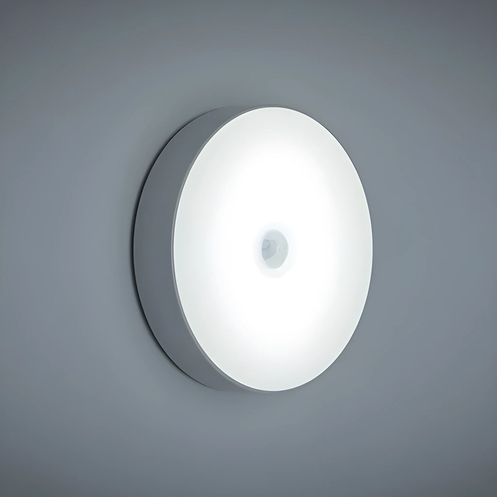 Compact beige motion sensing LED night light with USB charging port and adhesive backing