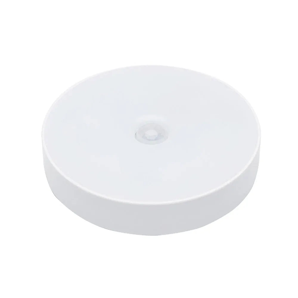 Compact beige motion sensing LED night light with USB charging port and adhesive backing