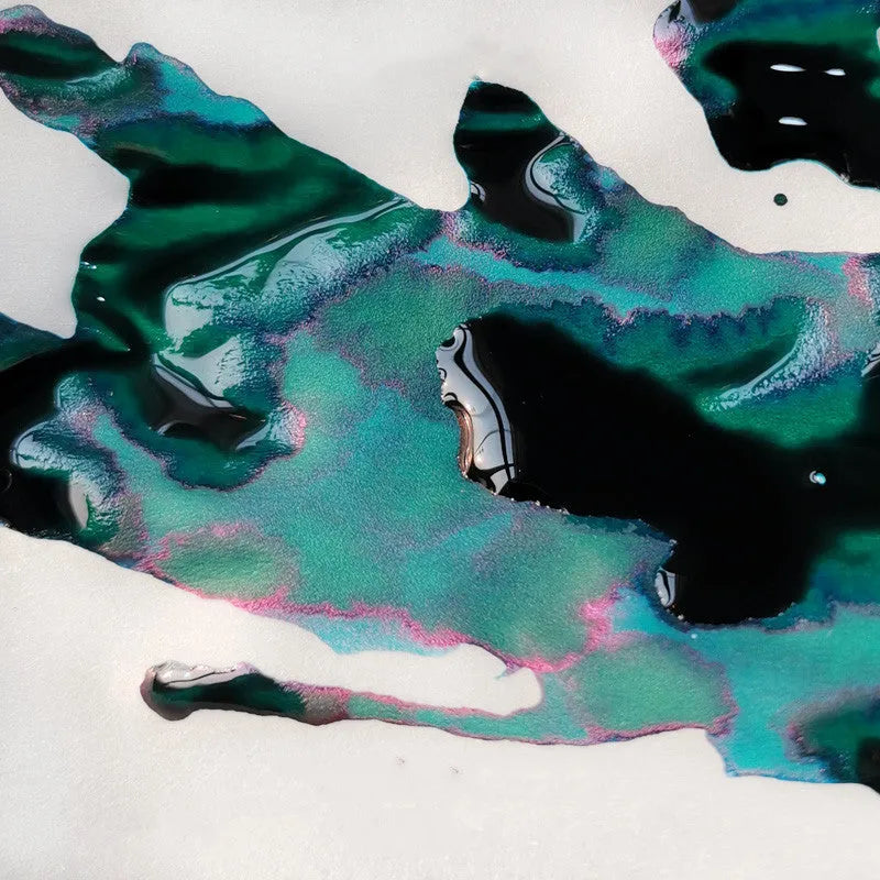 Bottle of gradient colour fountain pen ink with strong gold metallic sheen, Red Tide and Truffle variants.