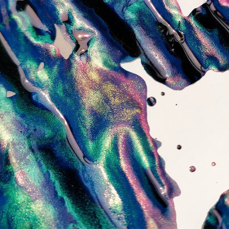 Bottle of gradient colour fountain pen ink with strong gold metallic sheen, Red Tide and Truffle variants.
