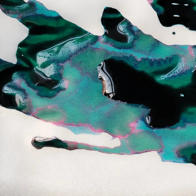 Bottle of gradient colour fountain pen ink with strong gold metallic sheen, Red Tide and Truffle variants.