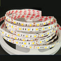 Close-up of a flexible white LED light strip with many small LEDs, coiled on a counter.