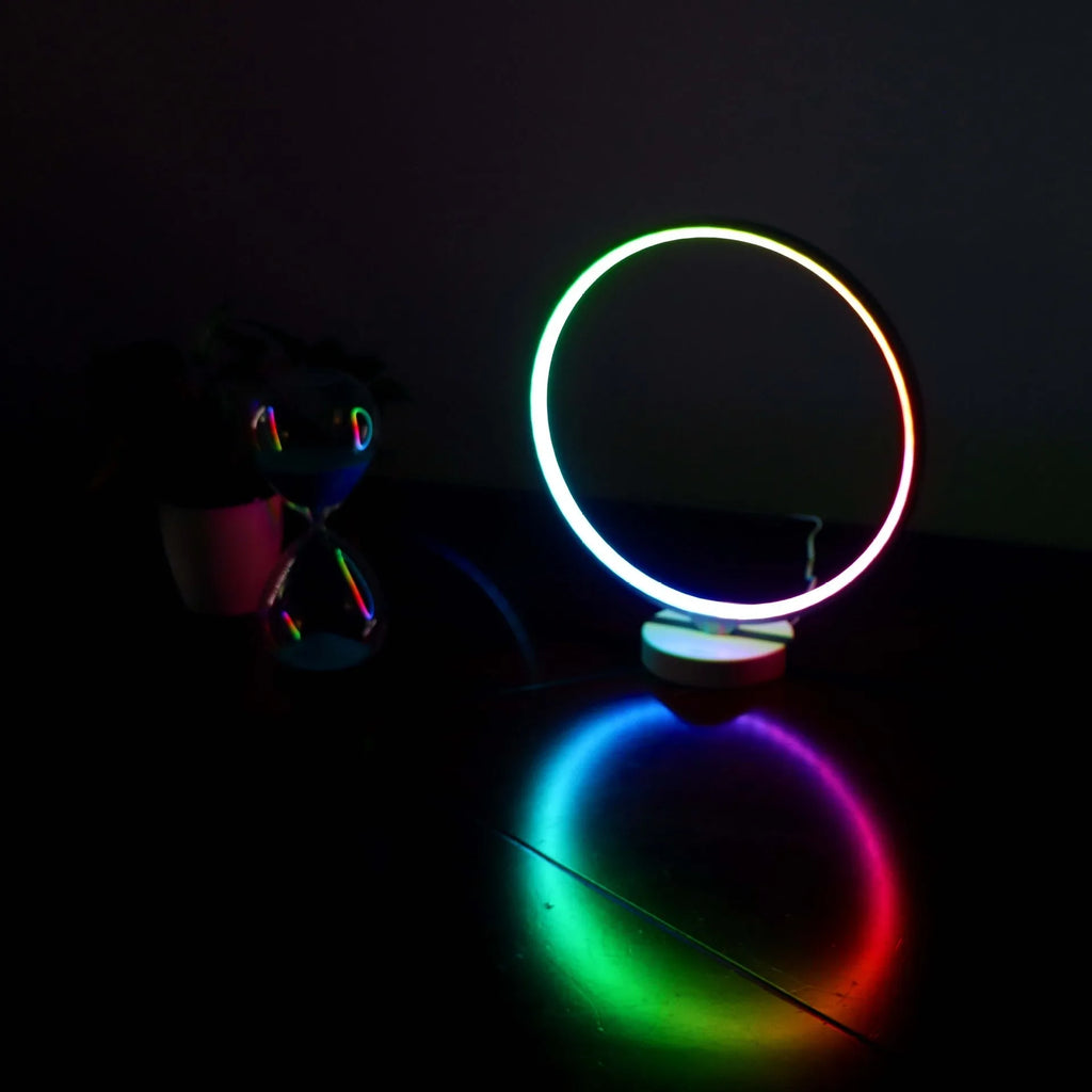 White Full Moon shaped LED table mood lamp with remote control on a wooden surface.