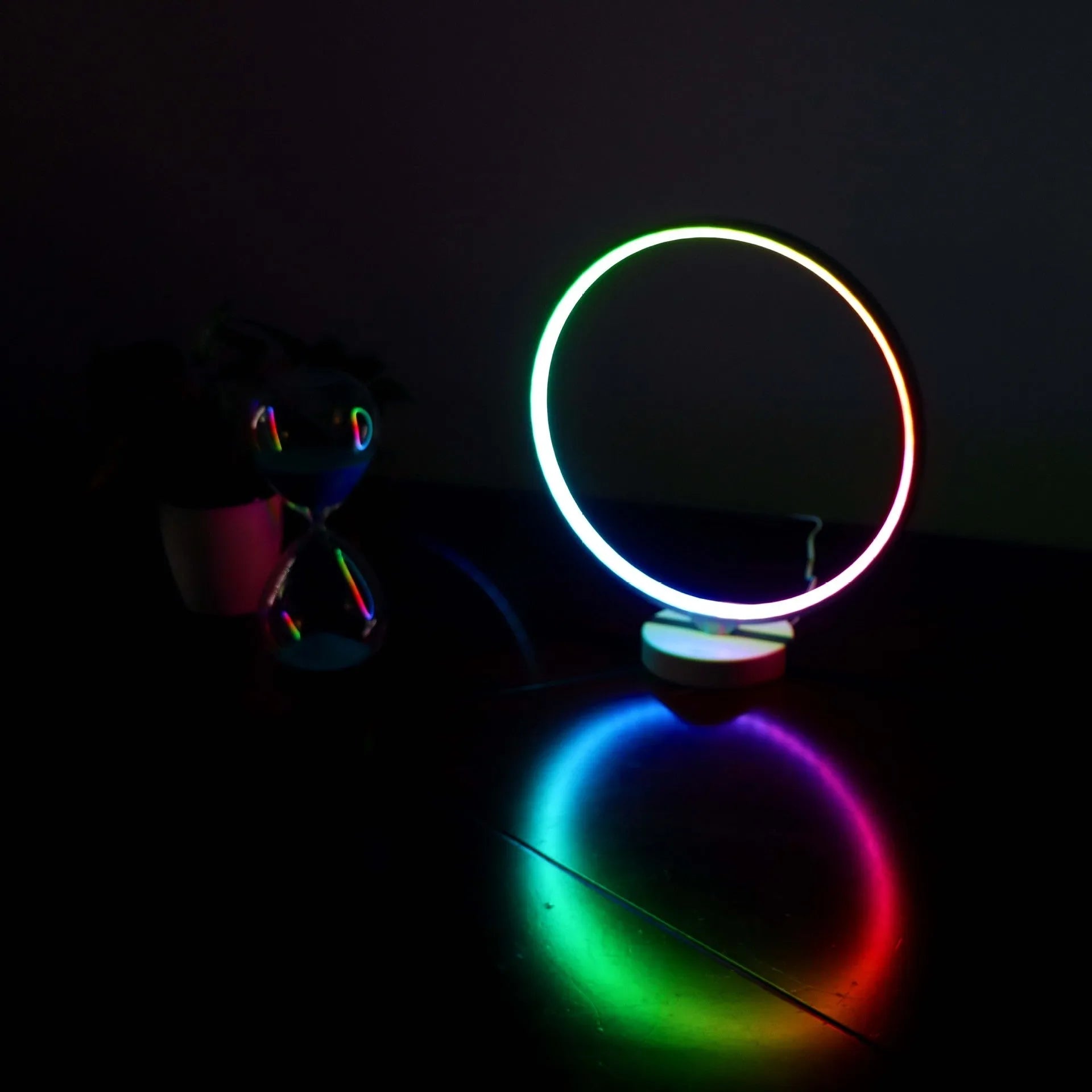 White Full Moon shaped LED table mood lamp with remote control on a wooden surface.