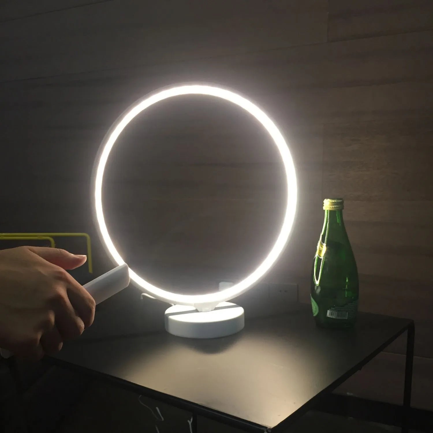 White Full Moon shaped LED table mood lamp with remote control on a wooden surface.