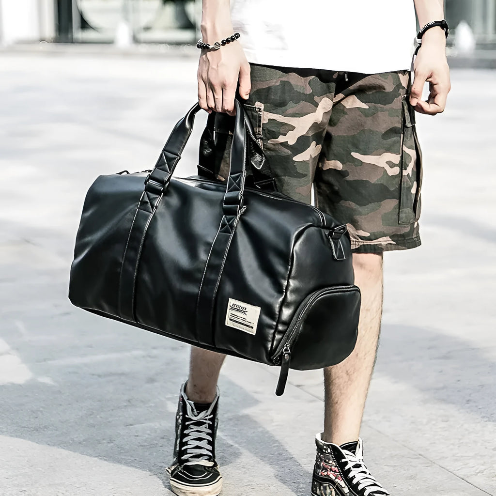 Large black waterproof PU leather sports training bag with a carry handle, shown open to reveal internal organiser pockets.