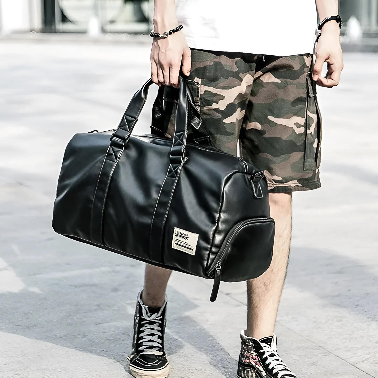 Large black waterproof PU leather sports training bag with a carry handle, shown open to reveal internal organiser pockets.