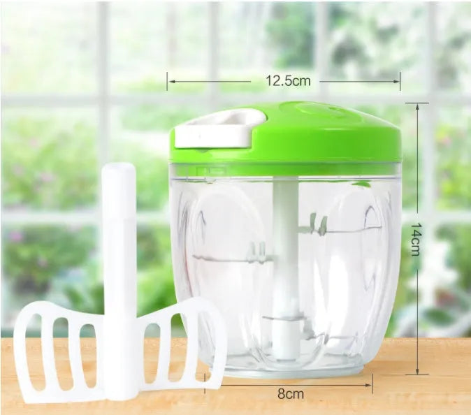 Green manual kitchen chopper with stainless steel blades and a clear lid, showing its compact size.