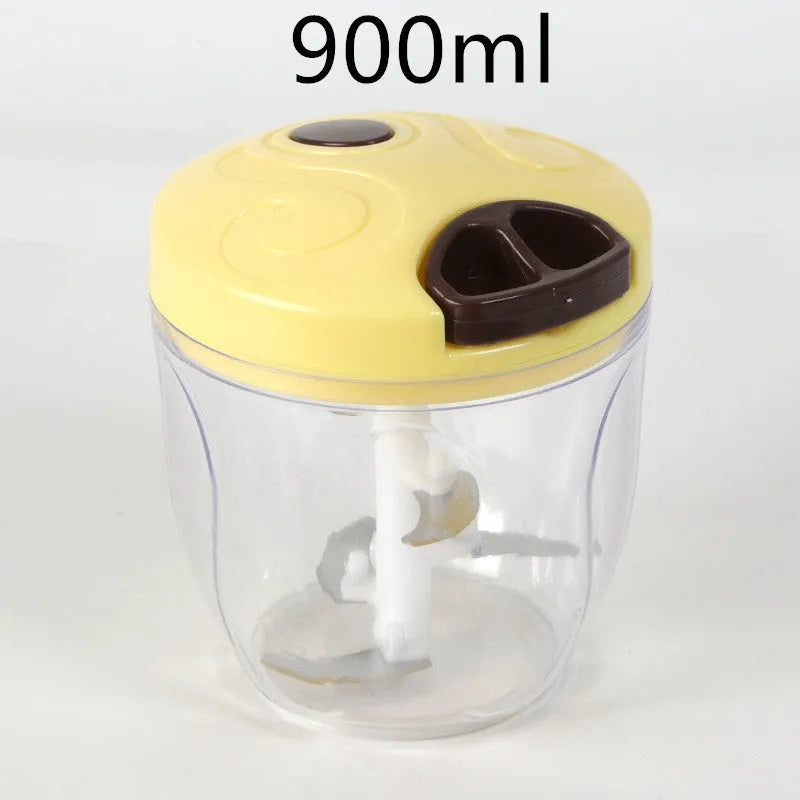 Green manual kitchen chopper with stainless steel blades and a clear lid, showing its compact size.