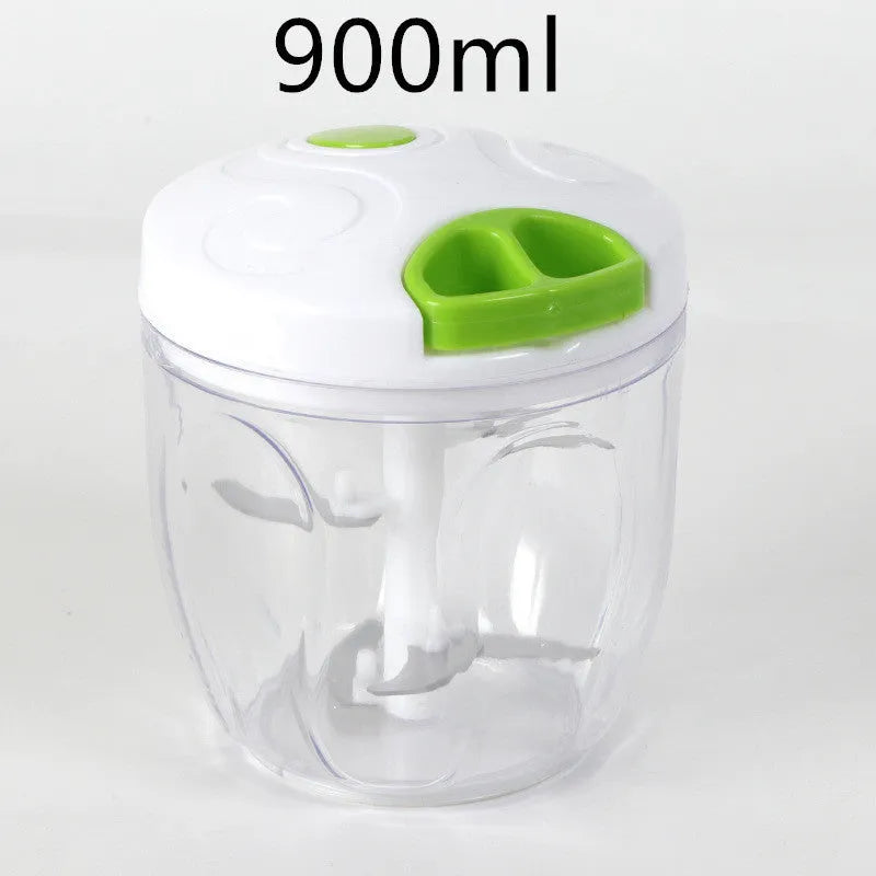 Green manual kitchen chopper with stainless steel blades and a clear lid, showing its compact size.