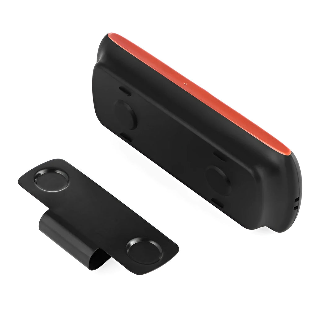 Orange Bluetooth car hands-free speaker unit mounted on a car sun visor
