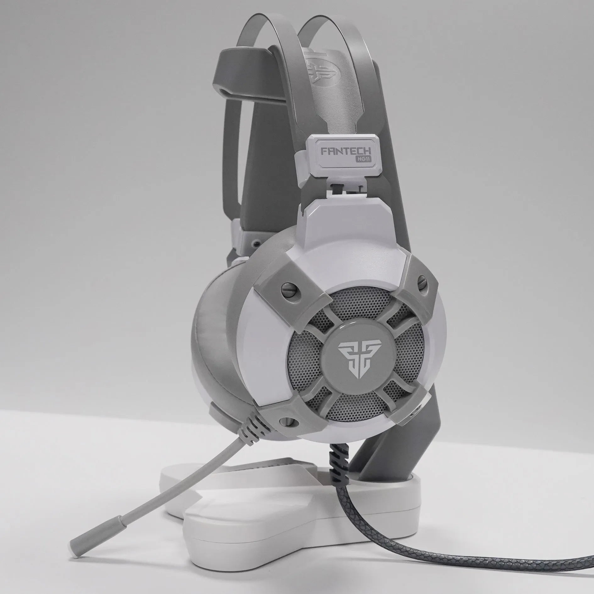 Black FANTECH HG11 USB gaming headset with RGB LED lights and a remote control on its cable.