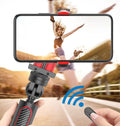 Black aluminium phone tripod with extended legs and a smartphone mounted in the clamp