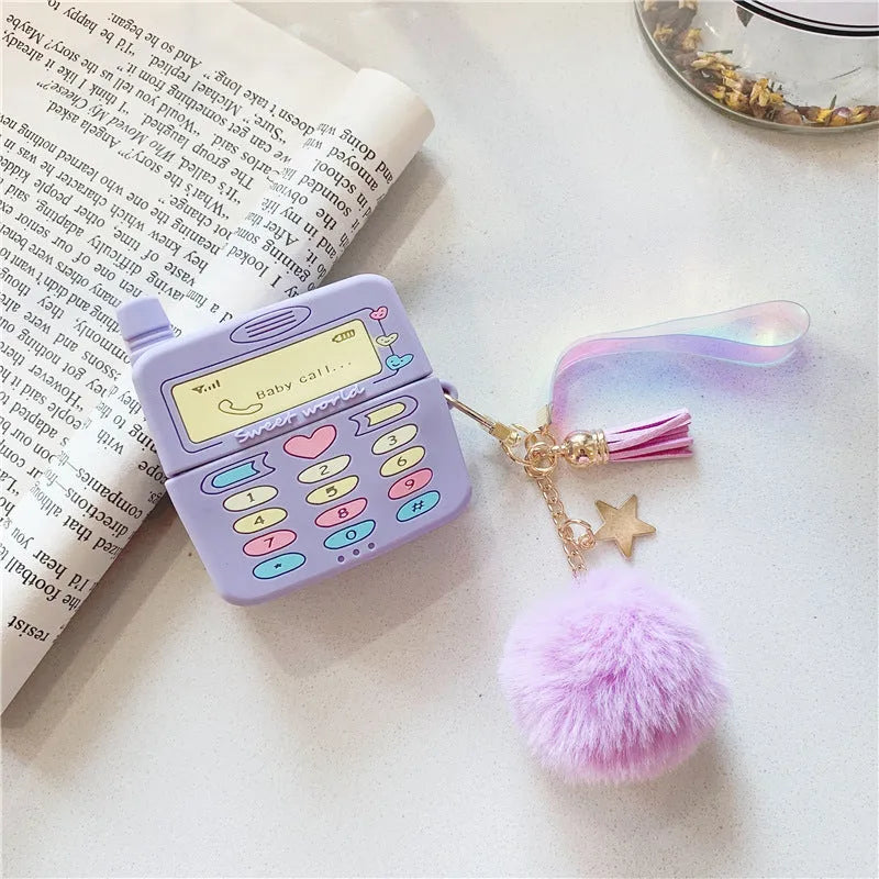 Purple silicone clamshell case for Apple AirPods with a white fur ball pendant attached.