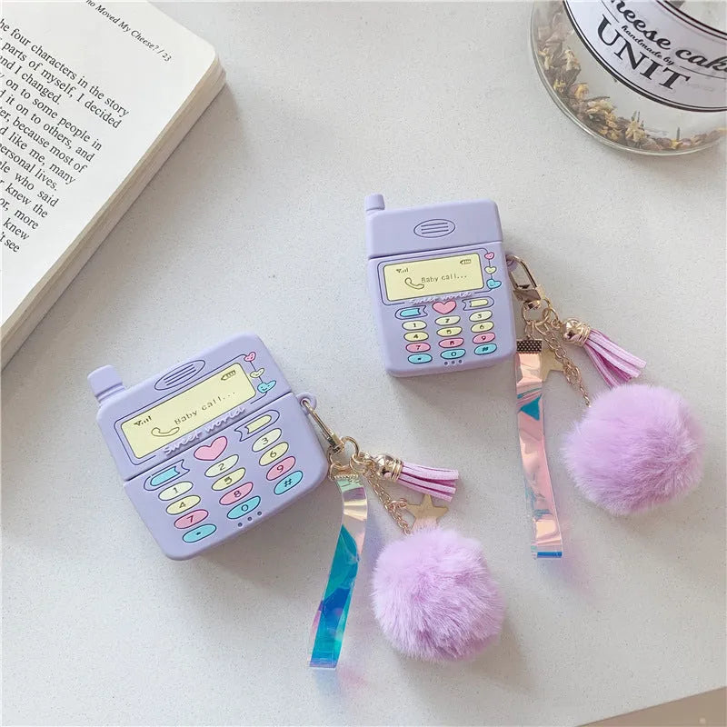 Purple silicone clamshell case for Apple AirPods with a white fur ball pendant attached.