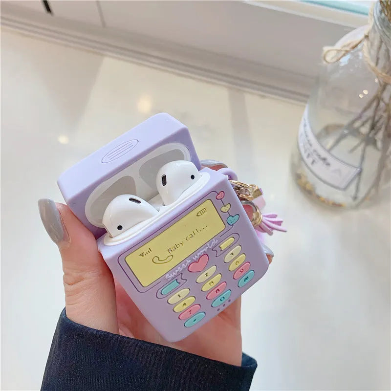 Purple silicone clamshell case for Apple AirPods with a white fur ball pendant attached.