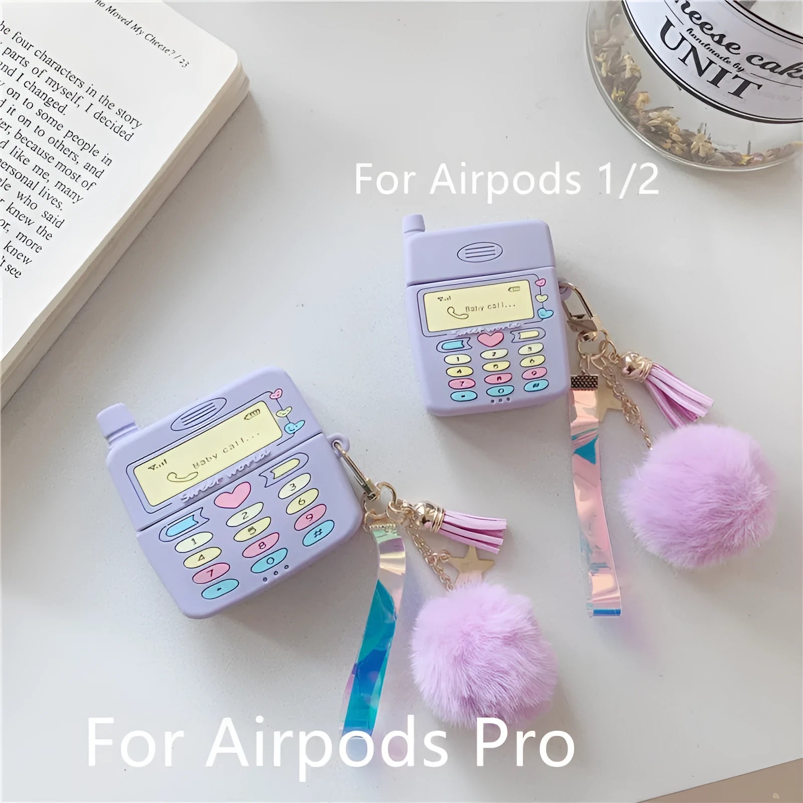 Purple silicone clamshell case for Apple AirPods with a white fur ball pendant attached.