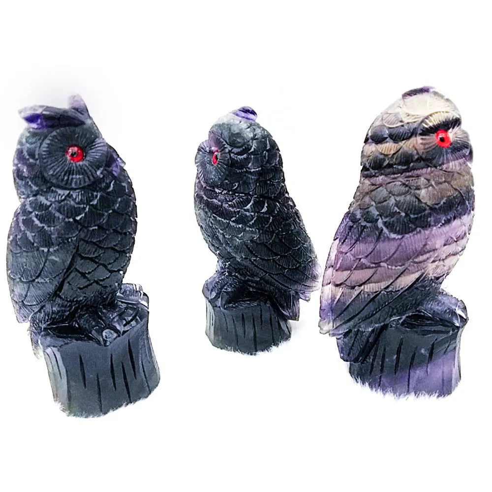 Purple fluorite carved owl statue on white background showing detailed hand carving