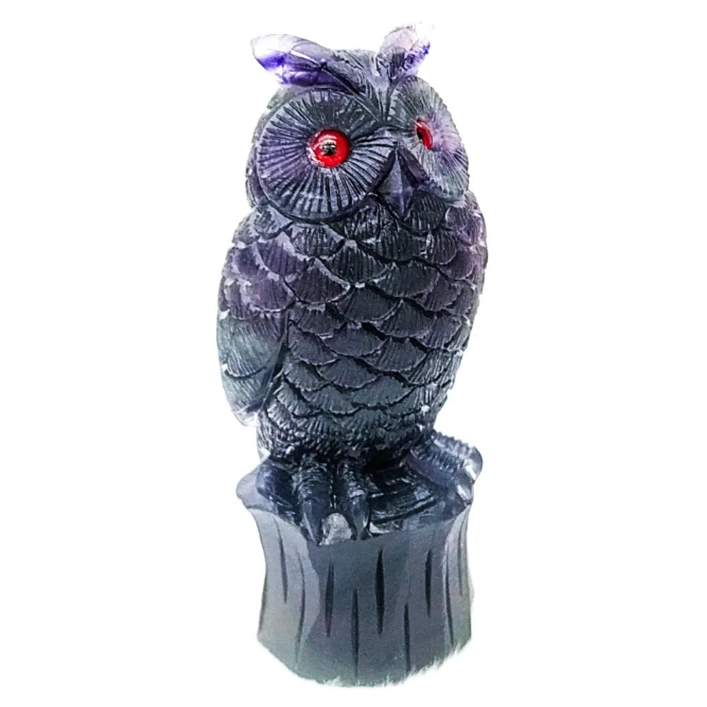 Purple fluorite carved owl statue on white background showing detailed hand carving