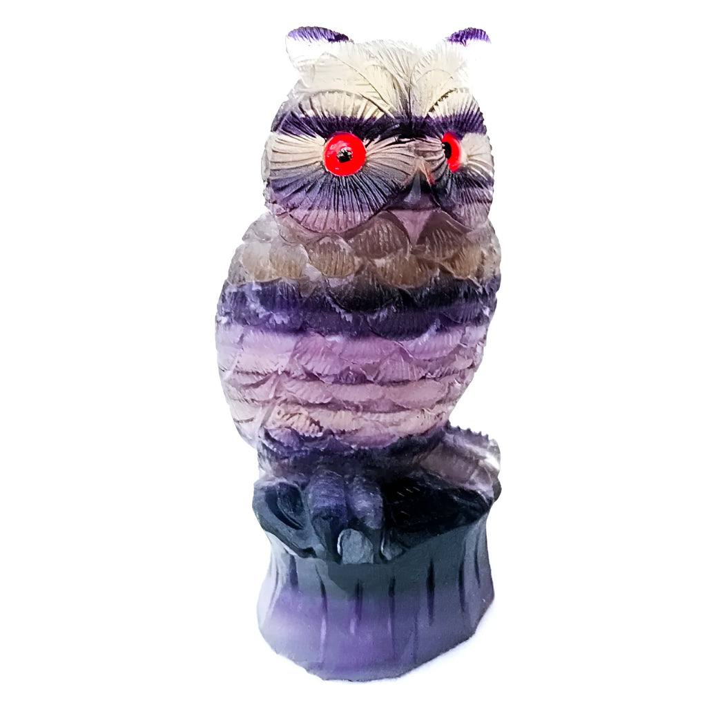 Purple fluorite carved owl statue on white background showing detailed hand carving