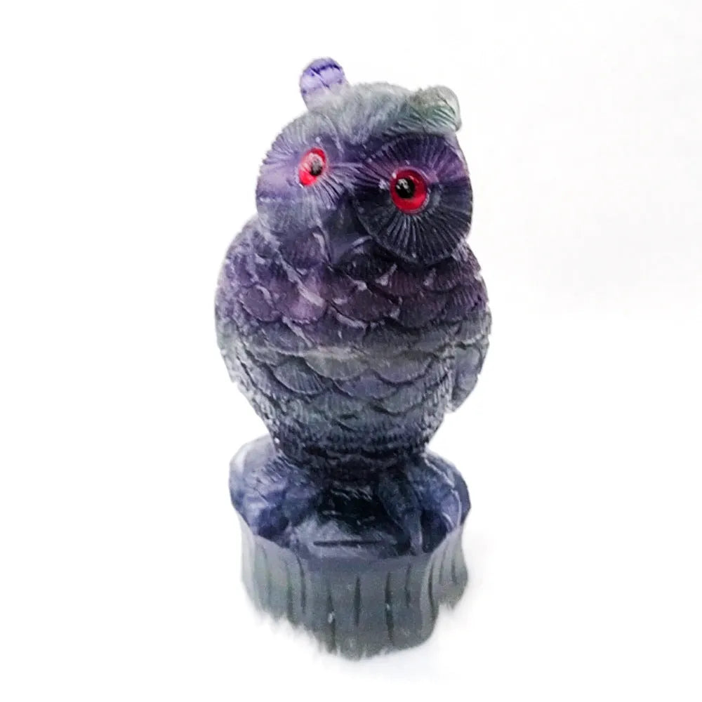 Purple fluorite carved owl statue on white background showing detailed hand carving