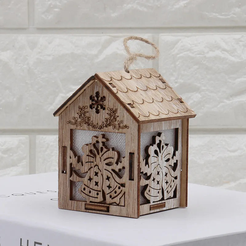 Set of three handmade wooden Christmas decorations: small log bell, wooden house Santa, wooden house snowman