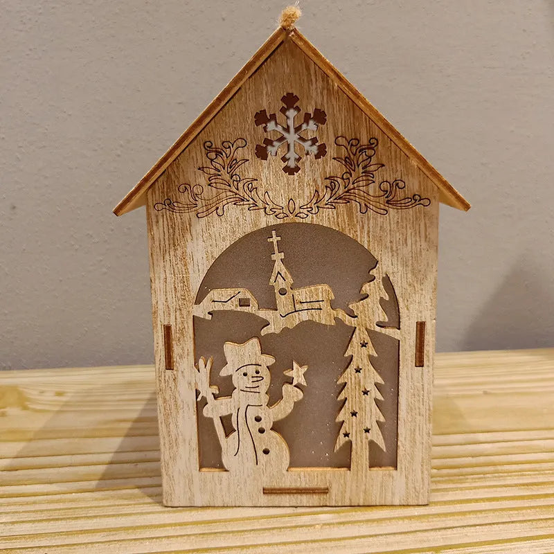 Set of three handmade wooden Christmas decorations: small log bell, wooden house Santa, wooden house snowman