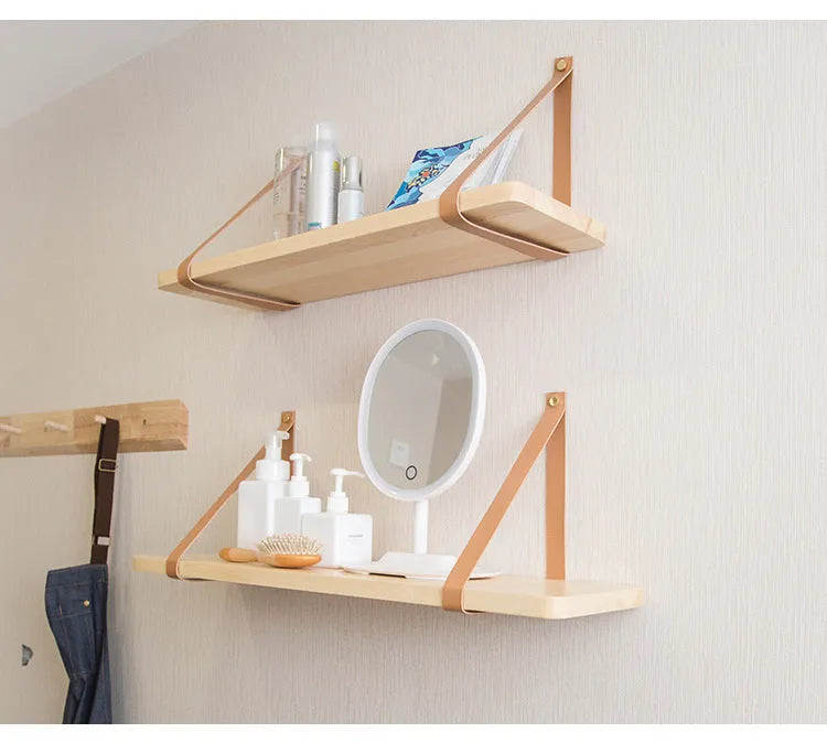 Pine wood wall-mounted storage shelf in Nordic style for organising books and remote controls.