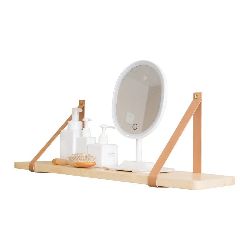 Pine wood wall-mounted storage shelf in Nordic style for organising books and remote controls.