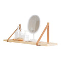 Pine wood wall-mounted storage shelf in Nordic style for organising books and remote controls.