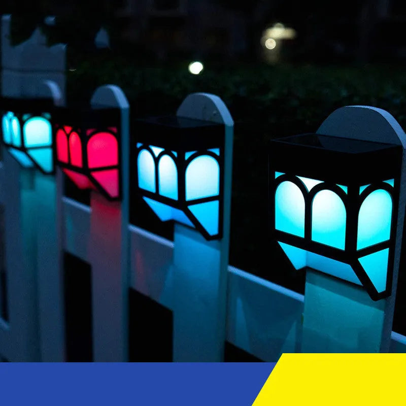 Square white solar-powered outdoor wall lamp mounted on a wooden fence post.