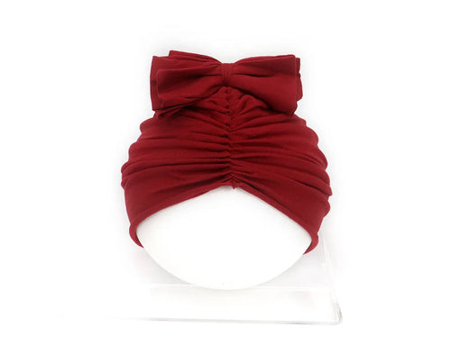 Soft knitted acrylic turban hat for baby girls, shown in a pink colour, fits head size 35-48cm.