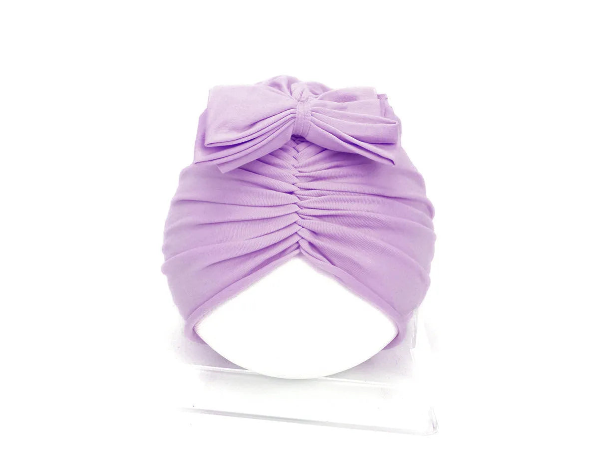 Soft knitted acrylic turban hat for baby girls, shown in a pink colour, fits head size 35-48cm.