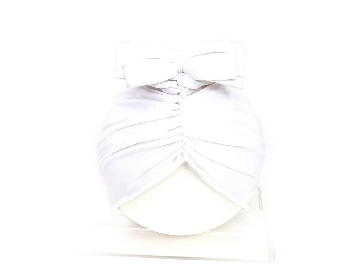 Soft knitted acrylic turban hat for baby girls, shown in a pink colour, fits head size 35-48cm.