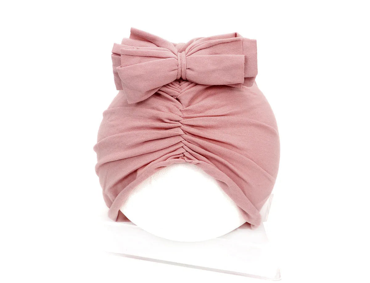 Soft knitted acrylic turban hat for baby girls, shown in a pink colour, fits head size 35-48cm.