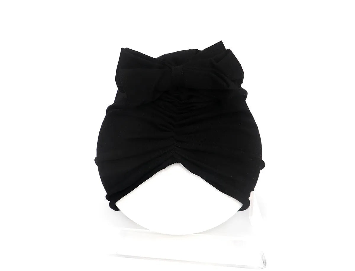 Soft knitted acrylic turban hat for baby girls, shown in a pink colour, fits head size 35-48cm.