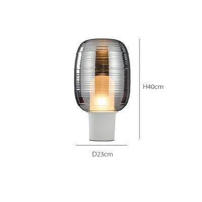 Simple modern Nordic style glass table lamp in cognac colour with push button switch.