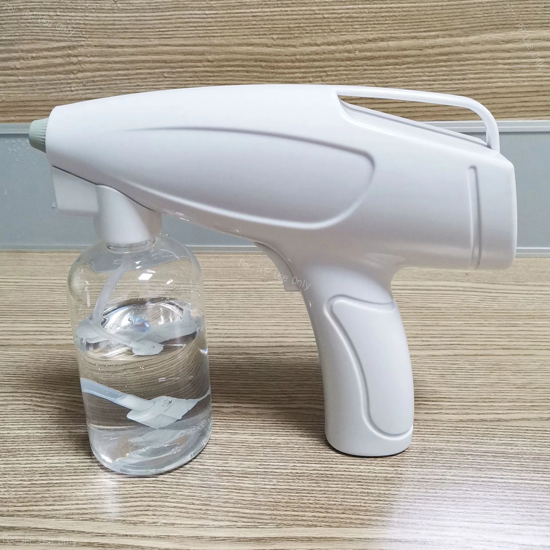 White handheld wireless electric disinfectant spray gun with USB charging port.