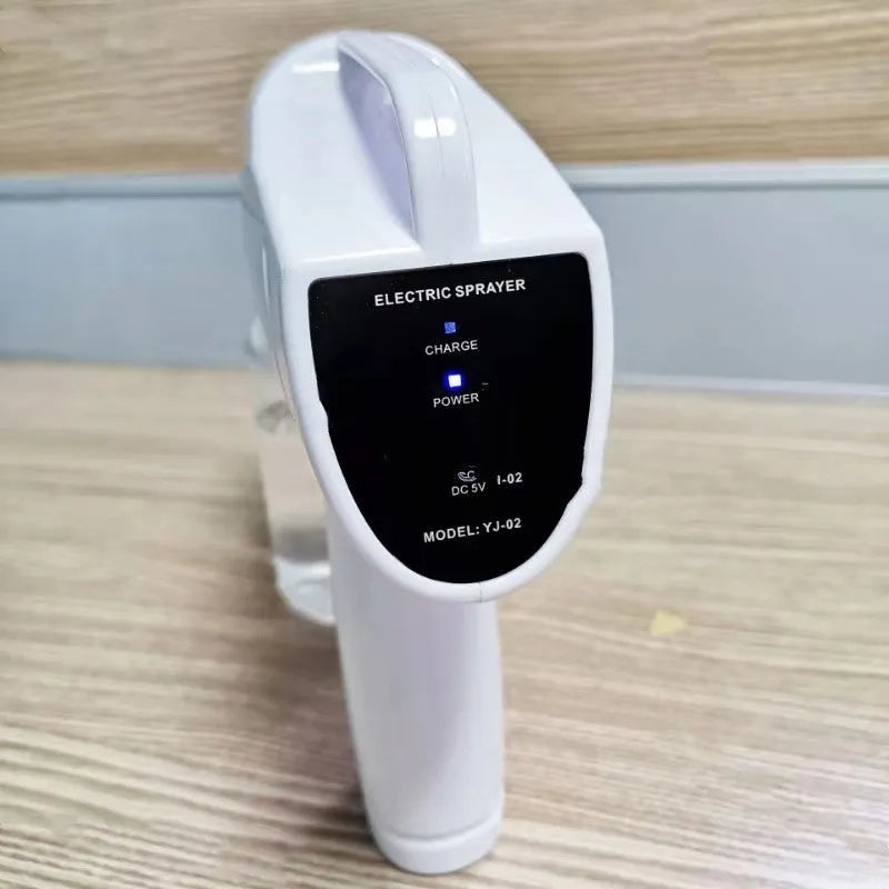 White handheld wireless electric disinfectant spray gun with USB charging port.