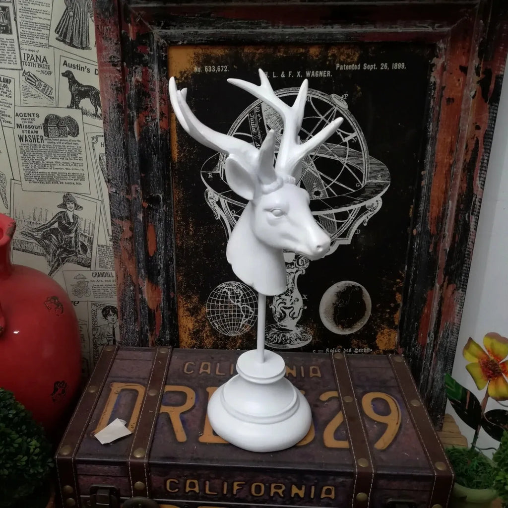 Natural resin decorative animal sculpture in black, white, or wood colour on a wooden table.