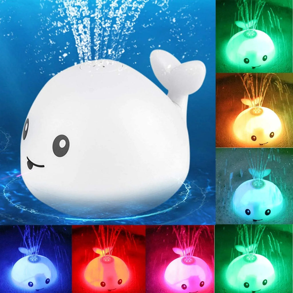 Whale-shaped electric bath toy spraying water with flashing lights, on a blue base.